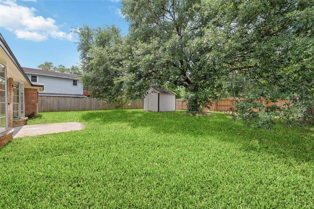 Backyard with a ton of space and a shed!