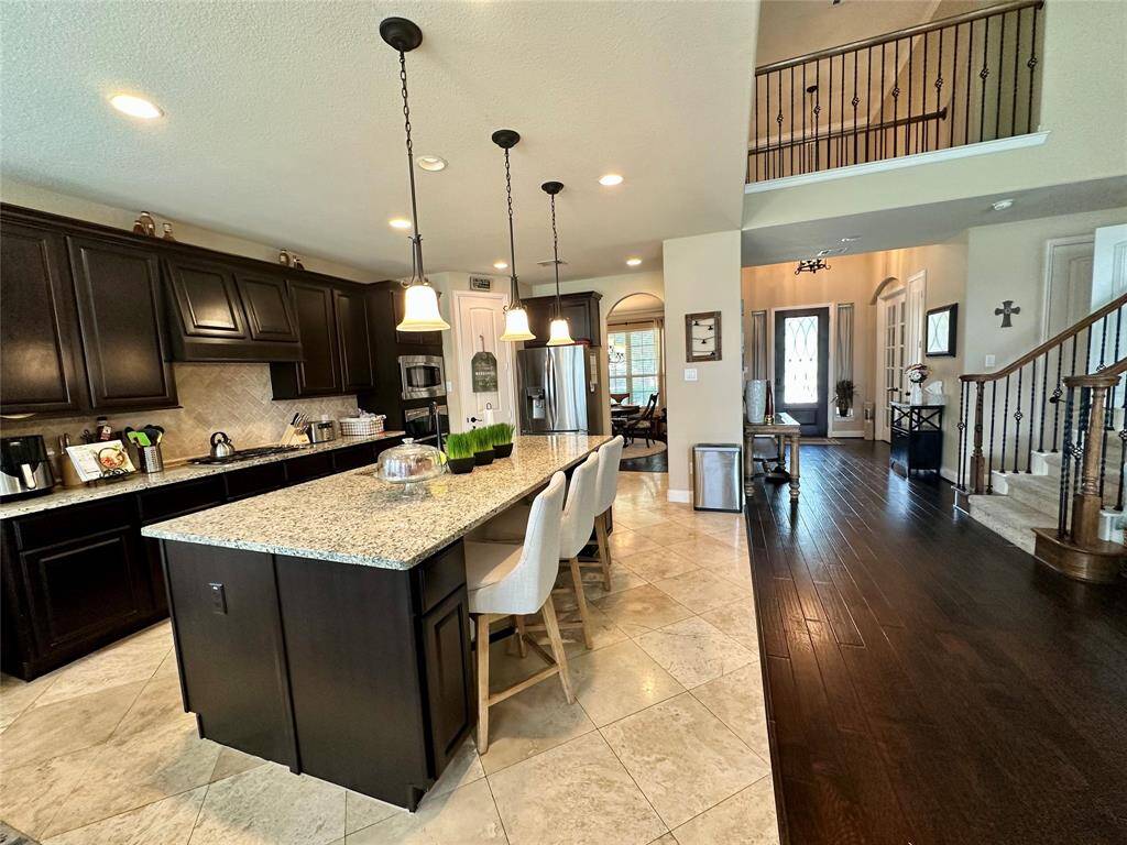 Discover your dream home at 10314 Hatcher Drive. This stunning residence features elegant brick and stone exteriors, a spacious two-car garage, and lush landscaping. Ideal for modern living, this property offers both comfort and style. Don’t miss this exceptional opportunity!