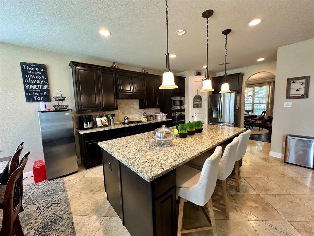 Discover your dream home at 10314 Hatcher Drive. This stunning residence features elegant brick and stone exteriors, a spacious two-car garage, and lush landscaping. Ideal for modern living, this property offers both comfort and style. Don’t miss this exceptional opportunity!