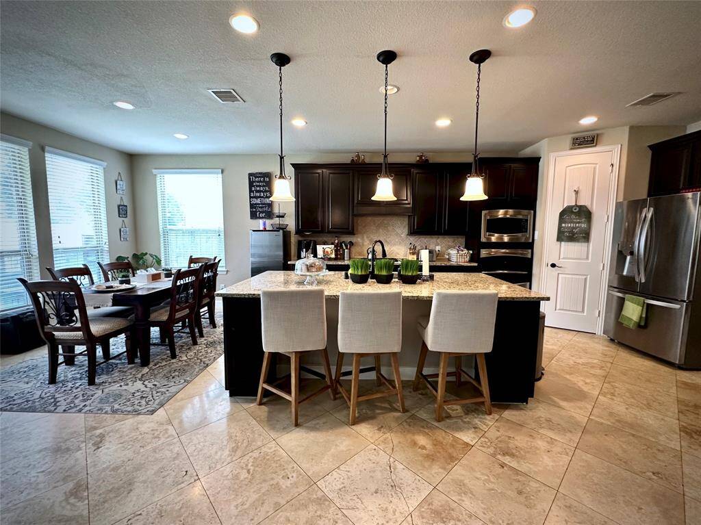 Discover your dream home at 10314 Hatcher Drive. This stunning residence features elegant brick and stone exteriors, a spacious two-car garage, and lush landscaping. Ideal for modern living, this property offers both comfort and style. Don’t miss this exceptional opportunity!