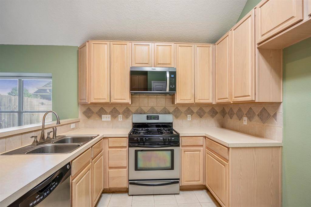 You'll enjoy cooking in this neutral kitchen with stainless appliances.