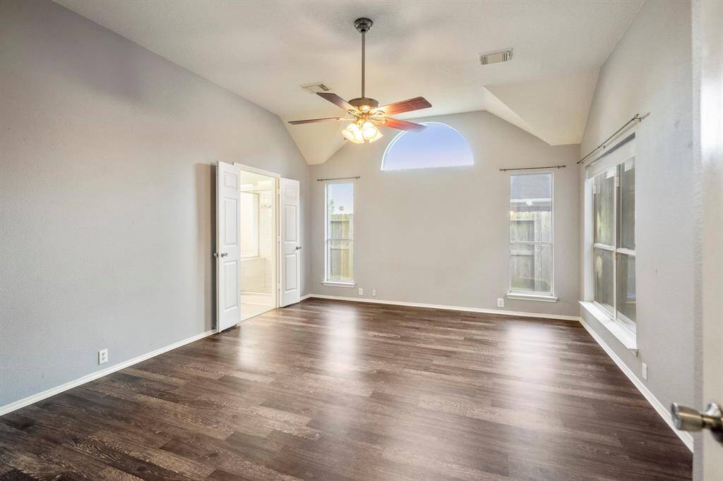 The primary bedroom, with high ceilings and lots of light.