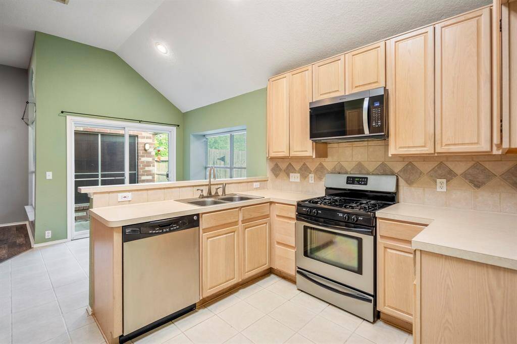 The kitchen, open to the living room and breakfast nook.
