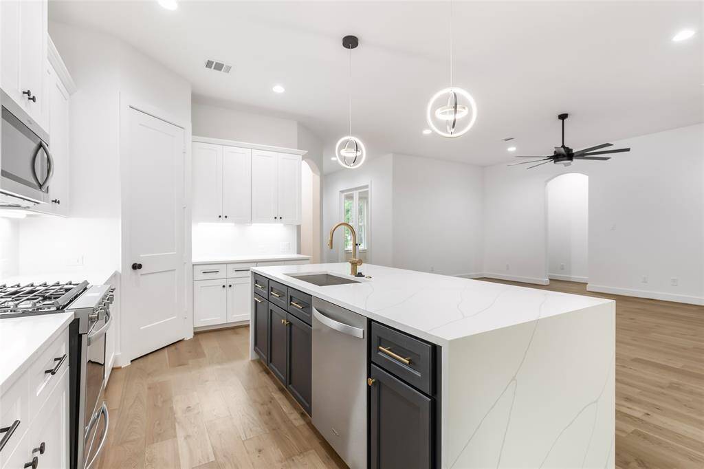 The island offers darker cabinets for a modern look