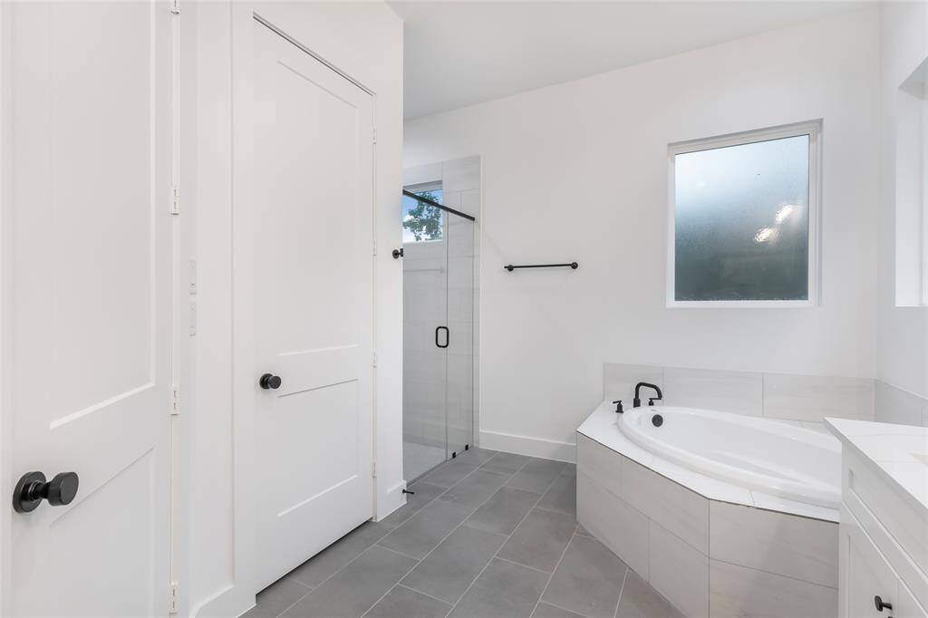 The primary bathroom offers a relaxing soaking tub