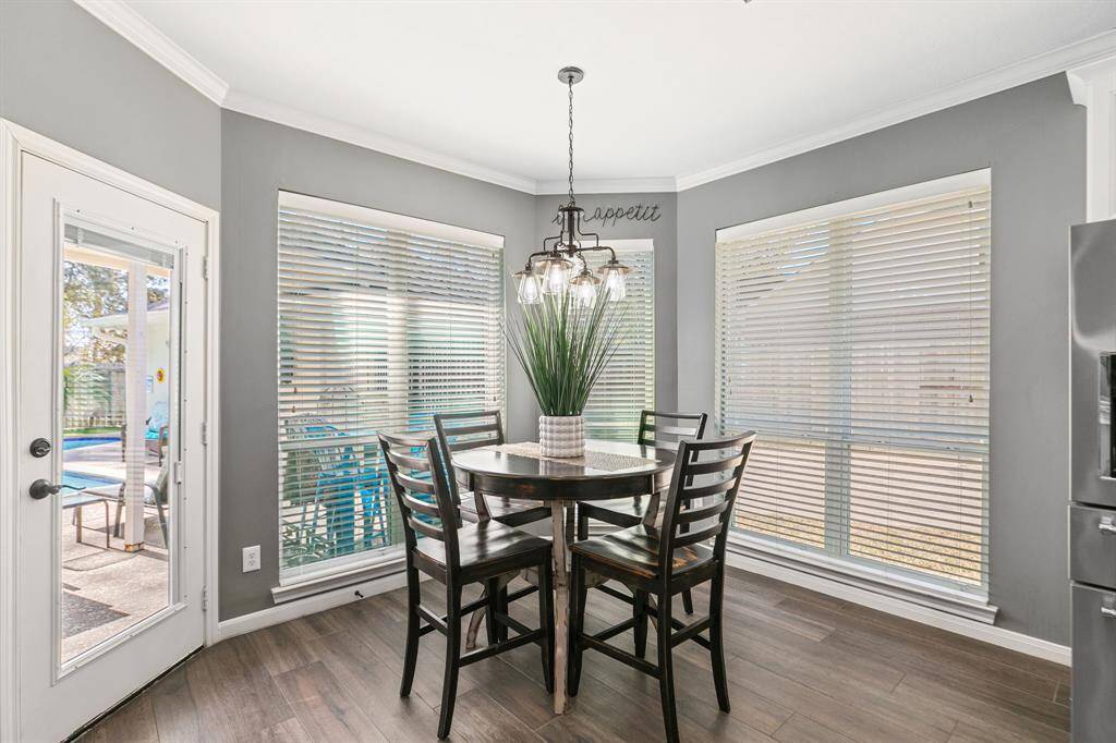 The breakfast area is located off the kitchen and can handle a crowd. It features a center fixture and views off the pool.