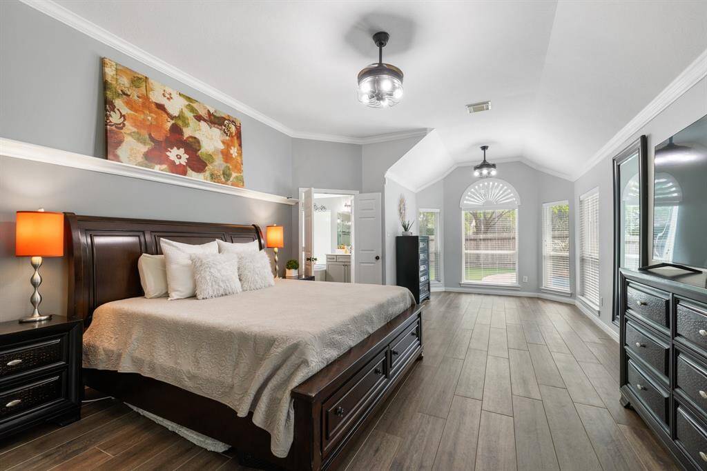 Retire each day in a primary suite that promotes relaxation. The primary bedroom is accented with a bay window seating/office are, two ceiling fans, and crown molding.