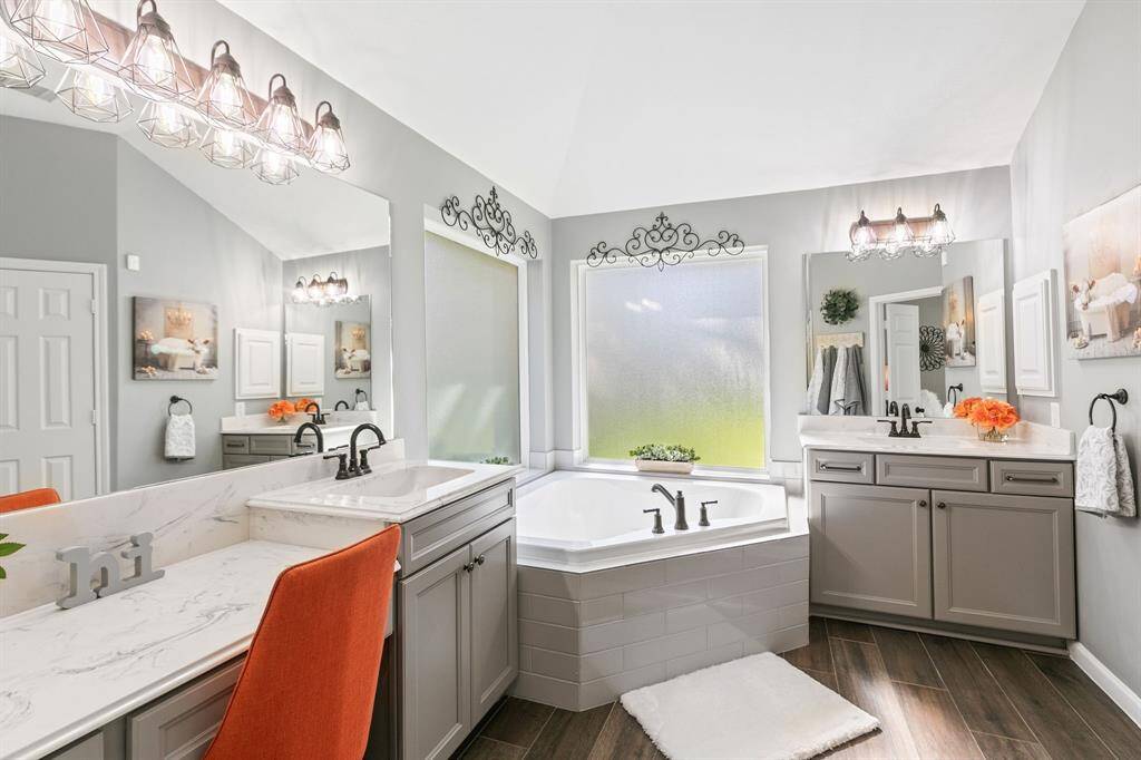 The dual vanities, large mirrors, walk in shower and corner bath tub will certainly enhance your morning and nightly routine.