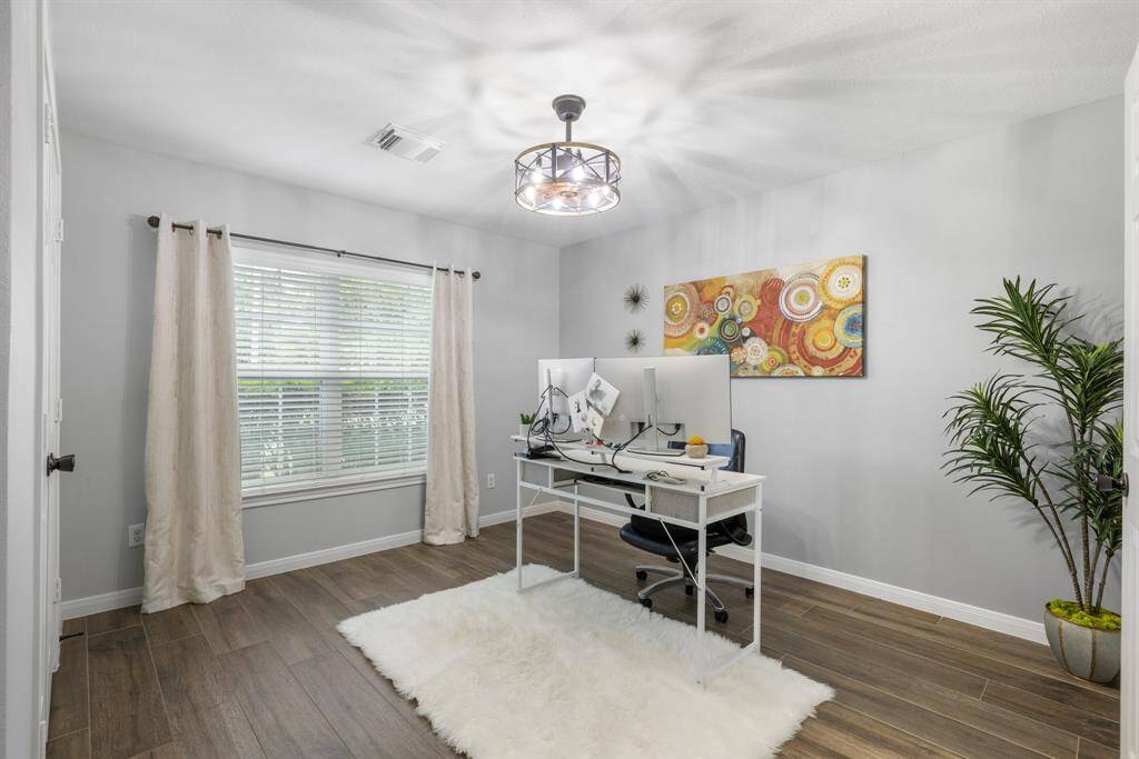 This second bedroom features a ceiling fan, walk in closet and tile floors.