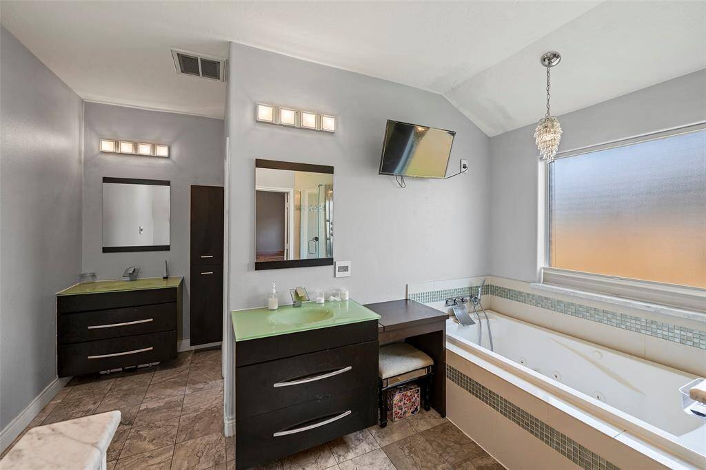 absolutely gorgeous, spa-like bathroom. Two vanity areas with an extra make-up vanity, extra wall heater, and wall mounted tv.