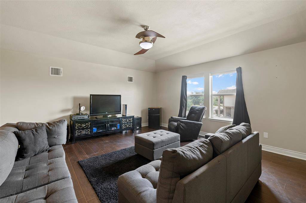 Nice flooring, light fixtures and fans, and roman blinds througout the home