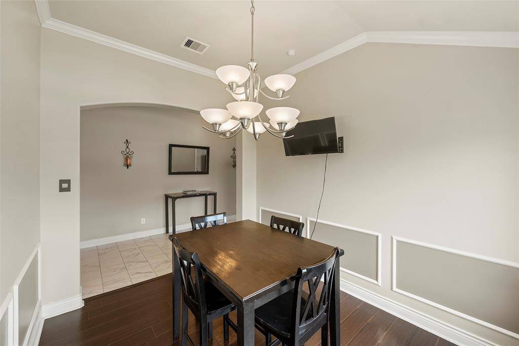 The second room on your left is this cozy formal dining room with a stylish chandelier
