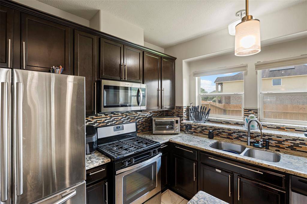 Stainless steel appliances, nice light fixture