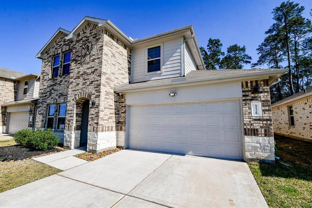 This two-story home features a charming brick and stone exterior.