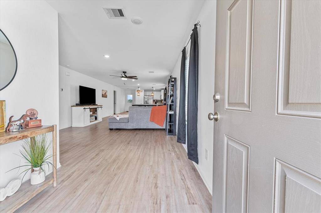Step into 126 Spring Rose through a welcoming entryway that sets the tone for the rest of the home. The space is bright and inviting, with clean lines and a smooth flow into the main living areas. Whether greeting guests or arriving home, the entry offers a warm first impression with its understated elegance and functional design.
