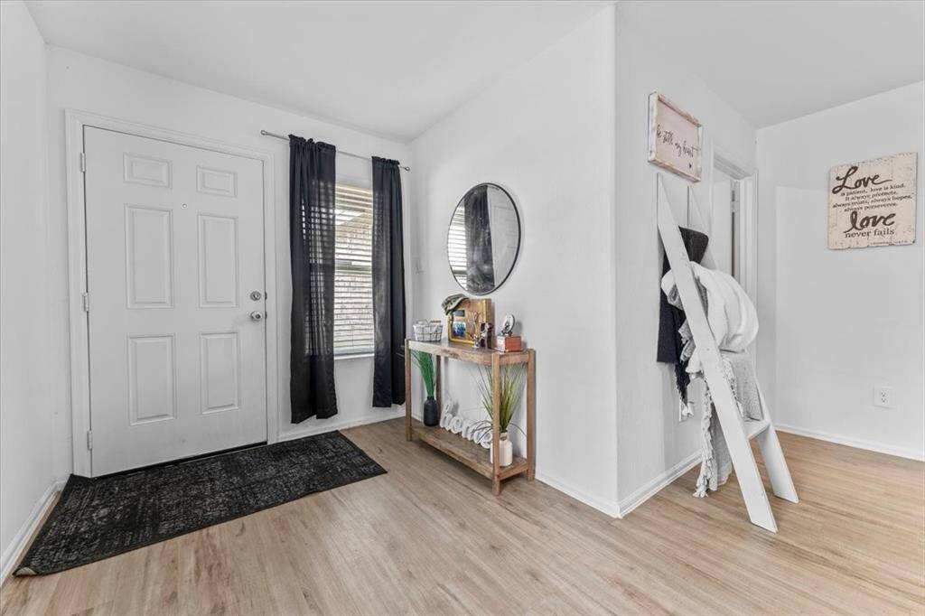 Just off the foyer, you’ll find convenient access to the utility room and garage—perfect for everyday ease and functionality. The thoughtful layout creates a smooth transition into the main living areas while keeping essential spaces close at hand.
