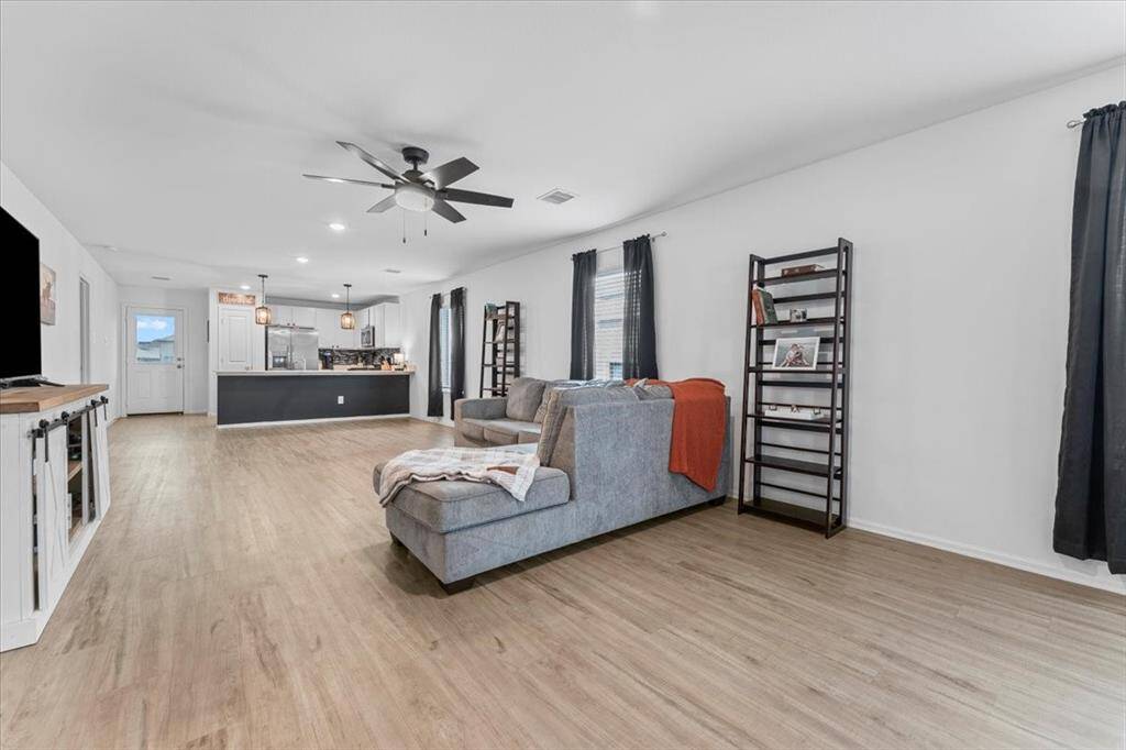 Plenty of windows throughout these connected spaces flood the home with natural light, creating a warm and inviting atmosphere that's perfect for everyday living and entertaining.