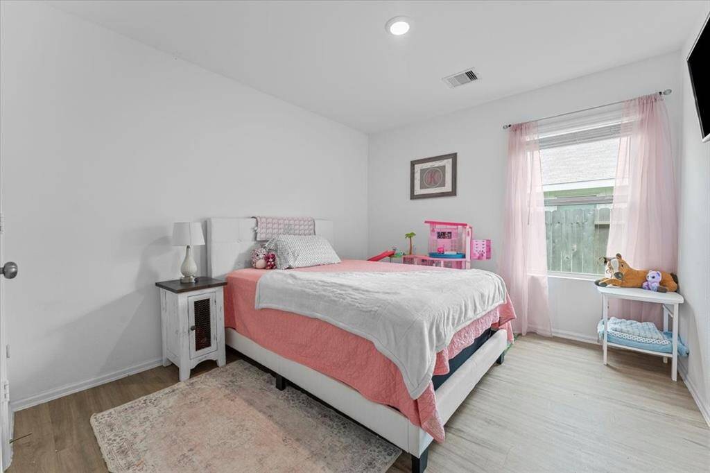 Both secondary bedrooms are generously sized at 11' x 10', offering plenty of room for comfort and versatility. Each room features natural light from a window, creating a bright and inviting atmosphere.