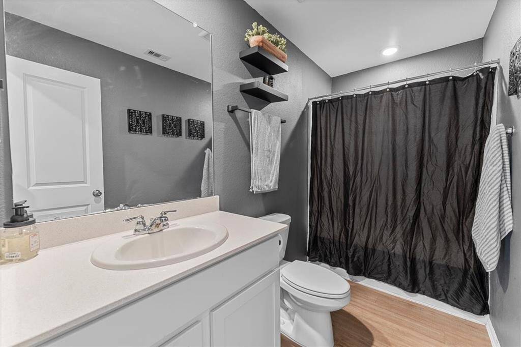 The second bath is absolutely gorgeous, featuring rich charcoal tones that create a sleek, modern feel. With its stylish color palette and high-quality finishes, it adds a touch of elegance and sophistication to the home.