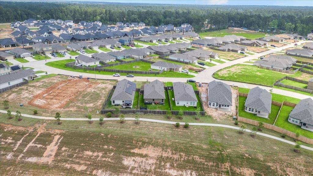 Built in 2022, this home is located in a growing community that is still expanding with new homes. The aerial view beautifully captures the surrounding area, giving you a glimpse of the ongoing development and the vibrant neighborhood in which this home is situated. It’s a fantastic location that combines modern living with the potential for future growth."