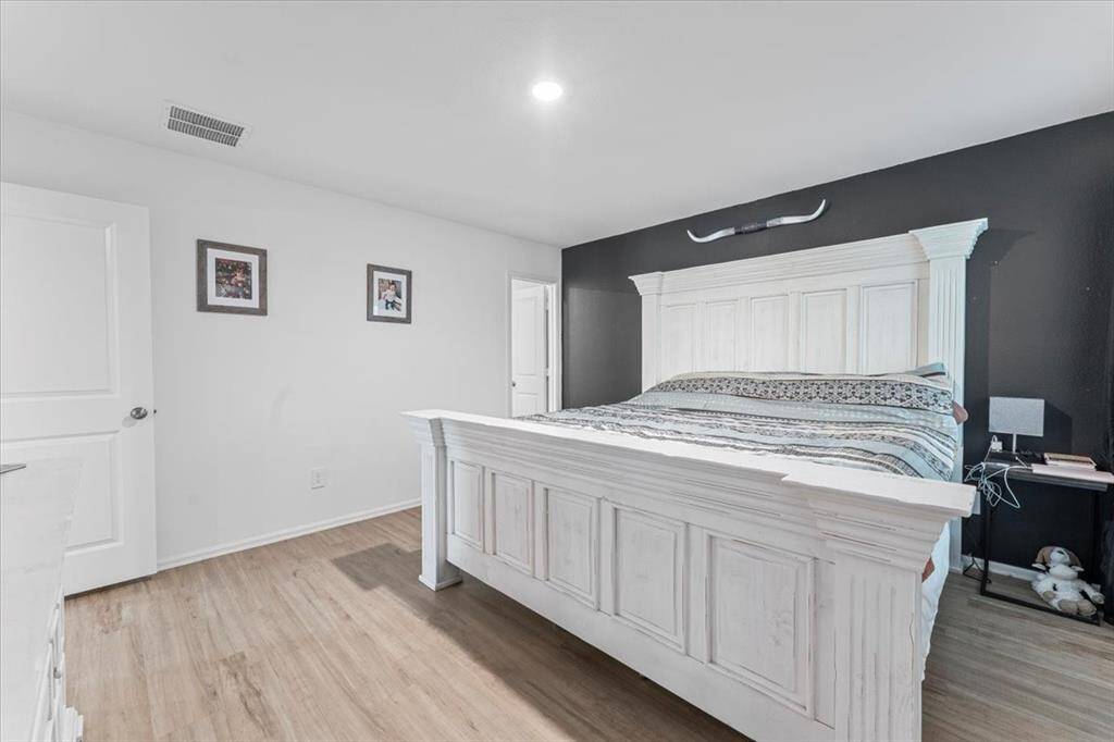 This 14' x 13' primary bedroom offers a comfortable and inviting retreat, with ample space for a king-sized bed and additional furnishings. It includes a private en-suite bath, adding convenience and privacy to this restful space.