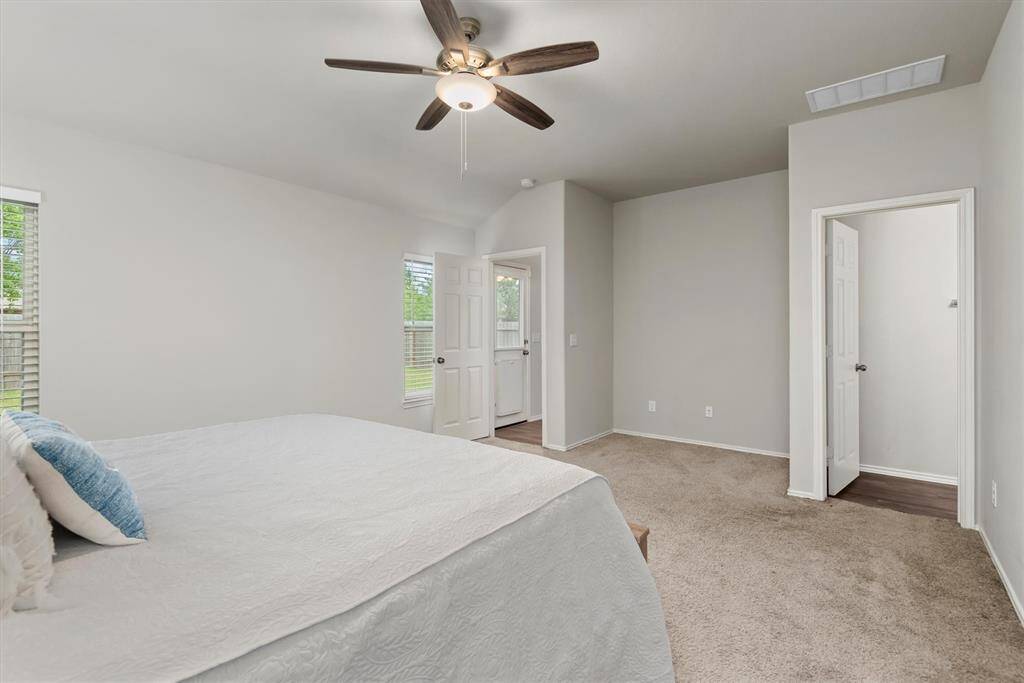 Another view of the primary bedroom highlights the entrance to the en-suite bathroom and reveals additional space—perfect for a reading corner, vanity, or extra storage.