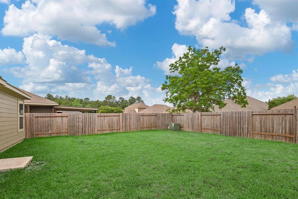 The spacious backyard has privacy fencing and plenty of green space.