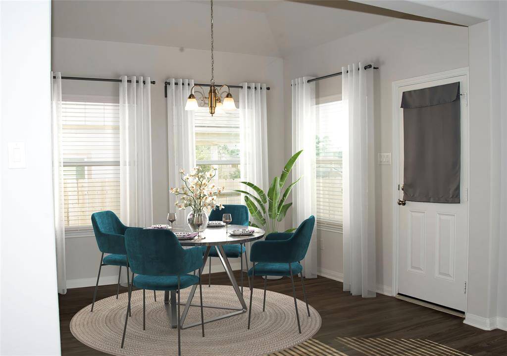 Bright dining space. Enjoy living in this well-cared-for space with durable, easy maintenance floors, mini-blinds and high ceilings! Move-In Ready. Digitally Staged.