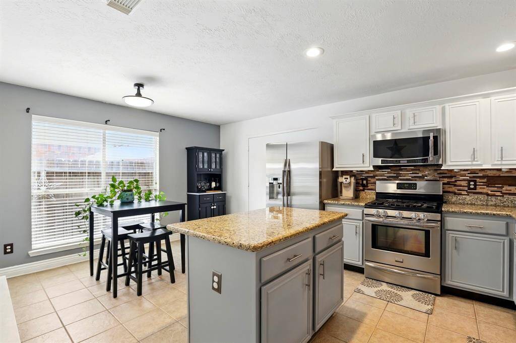 Open-concept kitchen with plenty of counter space and storage, ideal for everyday cooking and hosting guests.