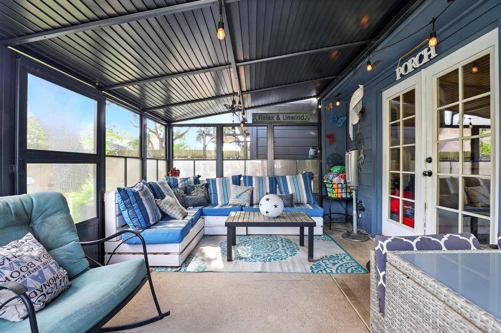 Relax year-round in the cozy enclosed porch — perfect for morning coffee, reading, or casual gatherings.
