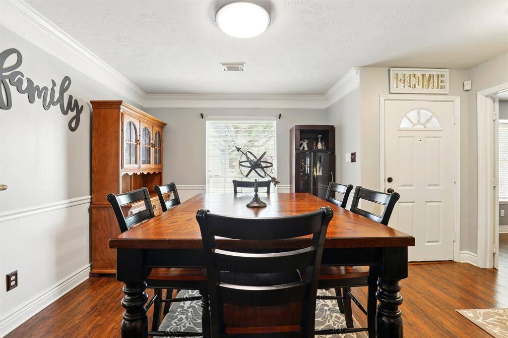 Beautiful dining space filled with natural light, seamlessly connected to the living room and kitchen.