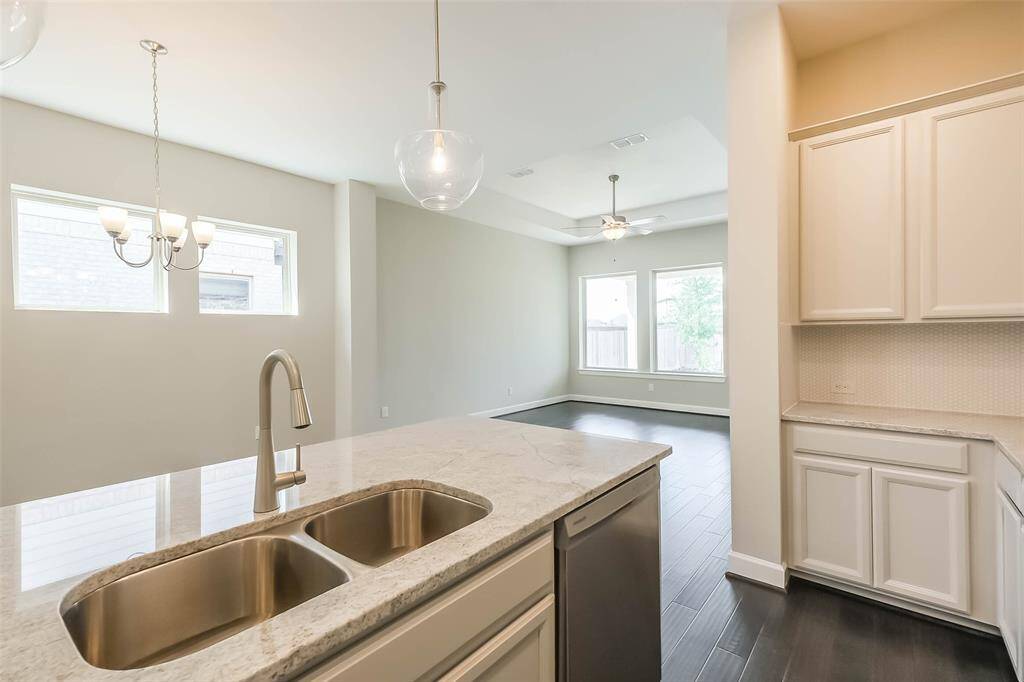 Kitchen features a stainless dishwasher, and easy access to either the dining or living area due to the open floor plan