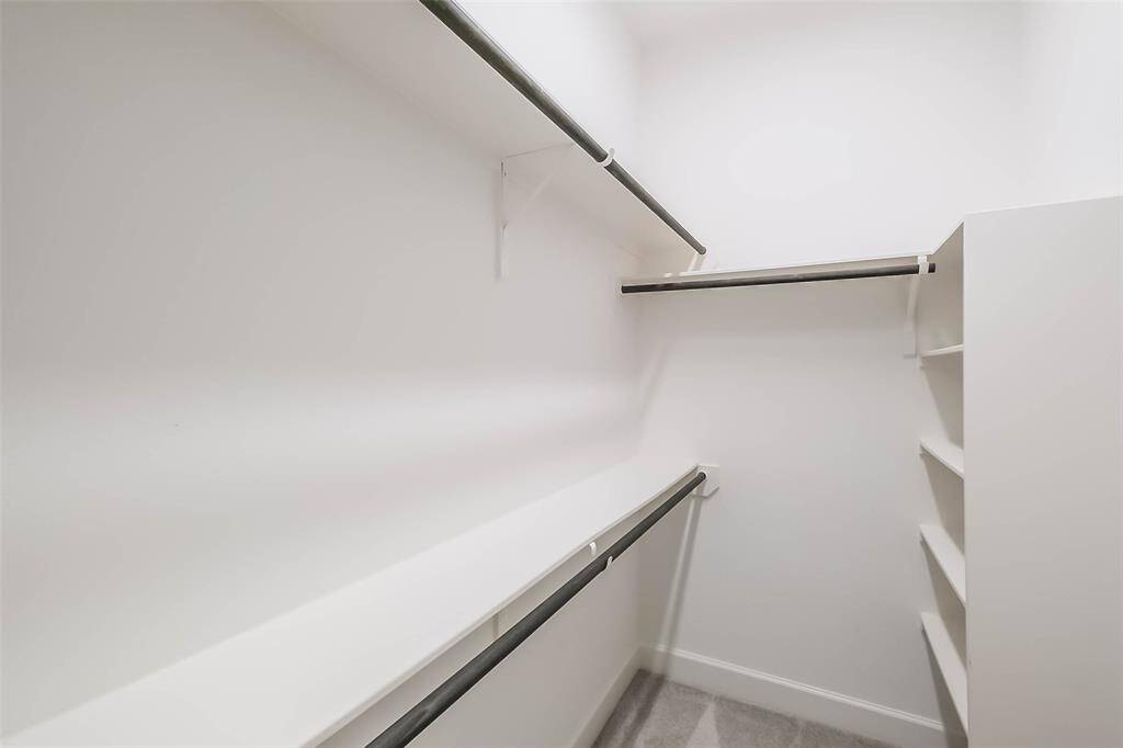 Spacious walk-in closet for the owner's retreat has plenty shelving for handbag storage, or a versatile shoe collection.