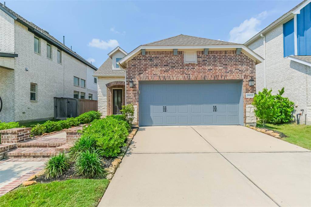 Plenty of room for parking in the spacious driveway. The 2-Car attached garage features handle accents, and coach lighting on either side.