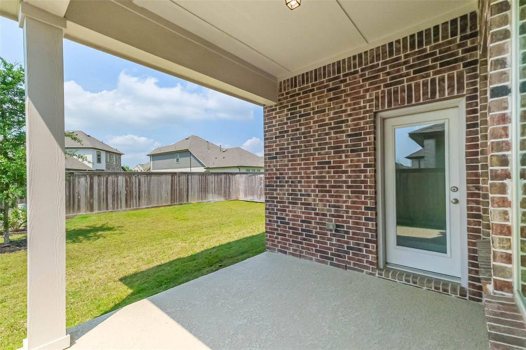 Covered back patio offers the perfect place for bistro furniture, or the outdoor grill enthusiast.