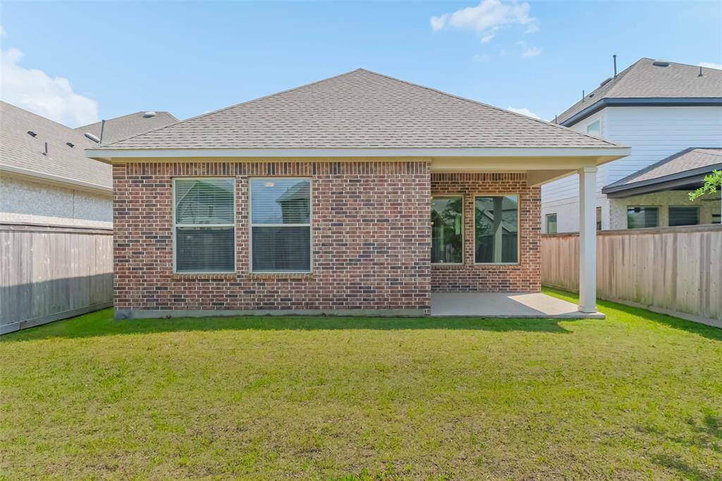 Another view from the backyard showcasing the beautiful brick surround.