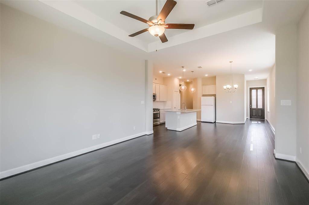 Another view of living/dining area, the front entrance is visible at the door on the right.