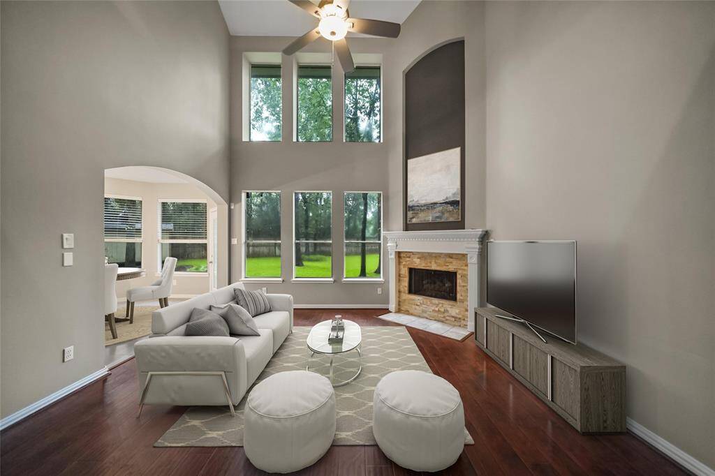 Large windows let lots of lighting in the room and the high volume ceilings give a dramatic effect to the home. "Virtually Staged".