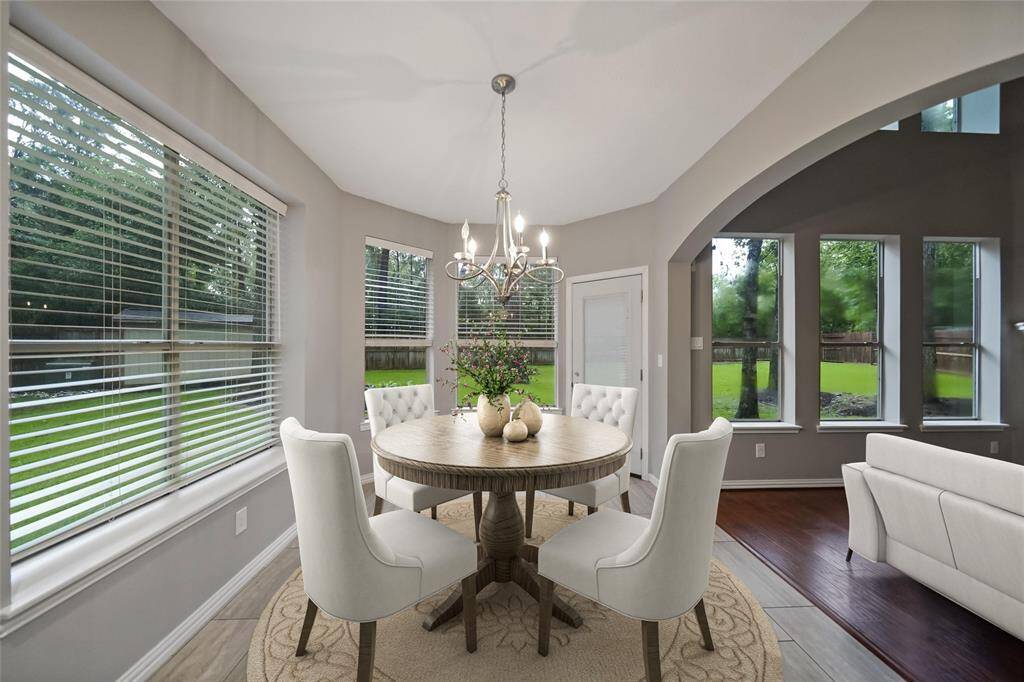 The breakfast room has views of the yard and offers new flooring and updated lighting. "Virtually Staged"