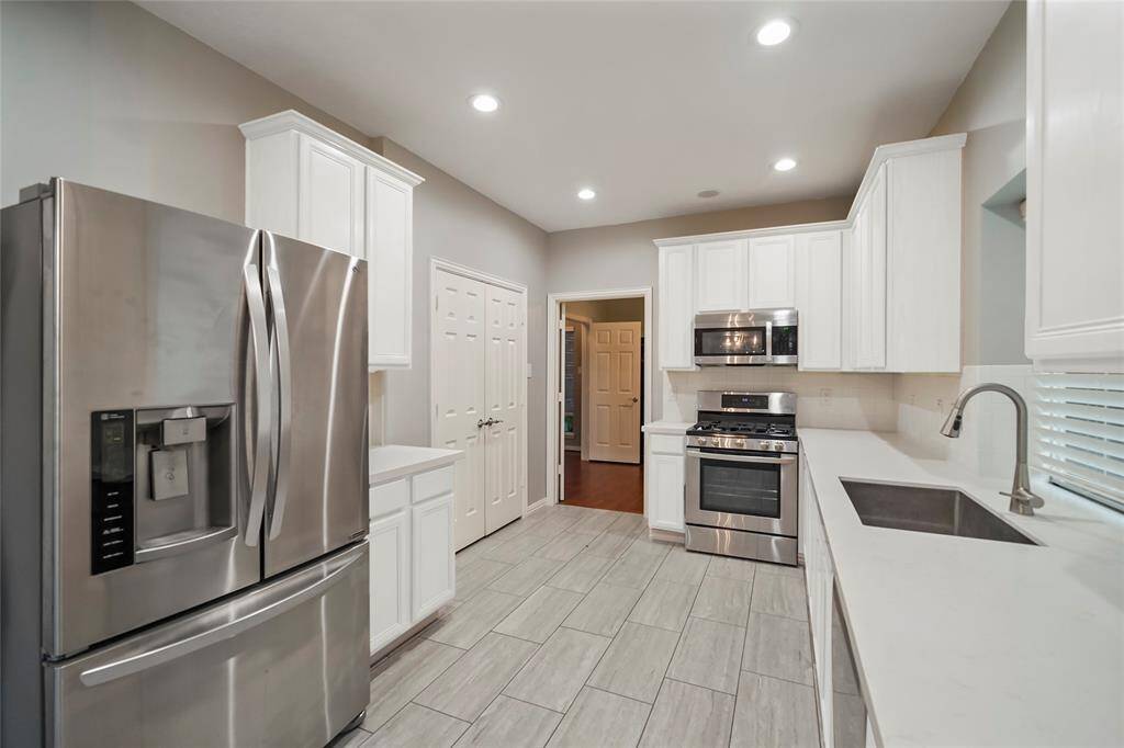 This updated kitchen has a two door pantry and doors that lead to the private study.