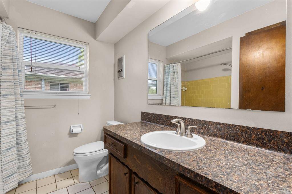 Hall bath with new countertops, sink and commode.