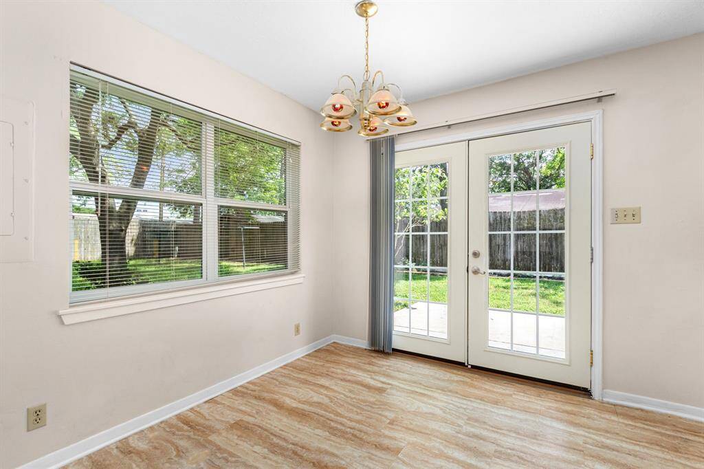 The dining area is spacious enough to accommodate a large dining table. The French doors lead to the large back patio.
