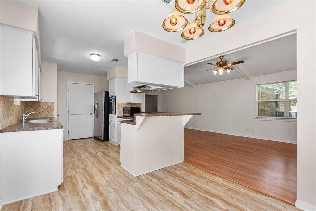 You will love the openness between the kitchen, dining and living area. The large wrap around bar is perfect for those meals on the go. Note the gorgeous updated kitchen.