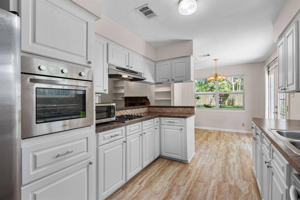 The kitchen is the heart of the home and this gorgeous one is sure to please. Beautiful white cabinets, stainless appliances and a 4 burner gas cooktop. The open concept allows you to stay in touch with guest while entertaining.