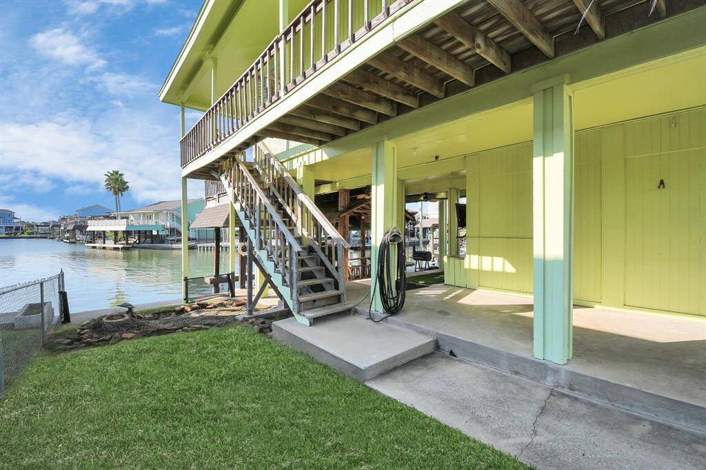 This home features a convenient carport and elegant stairs leading to an elevated entrance, offering both style and functionality.