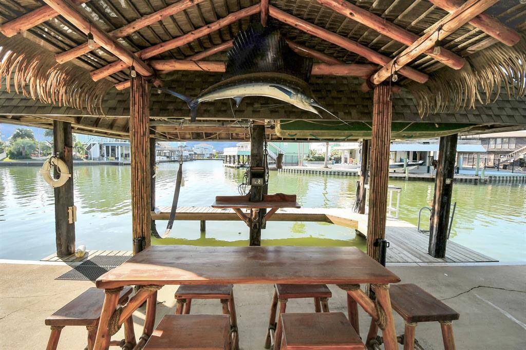 It features a scenic view of a canal, perfect for relaxing or entertaining, with easy water access for boating or fishing.
