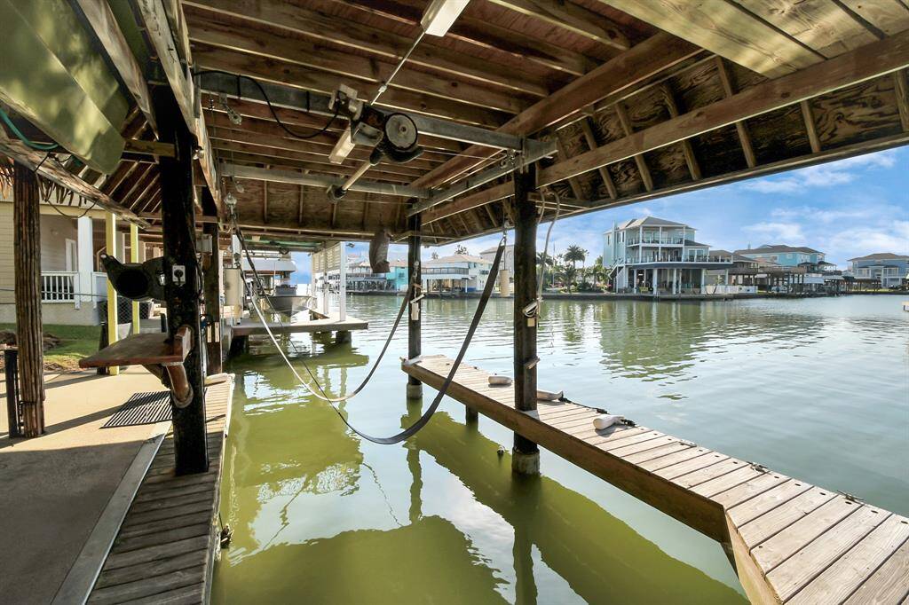 With a covered boat dock, that offers direct access to a serene canal. This  provides a picturesque and tranquil living environment for water enthusiasts.