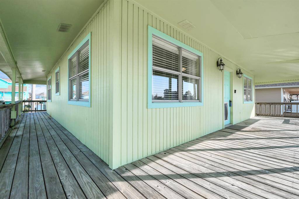 Spacious covered deck with main entrance overlooking the canal.