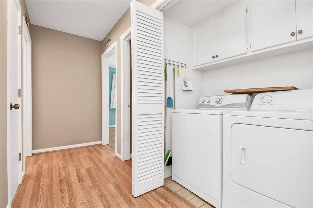 Convenient utility closet featuring a full-size washer and dryer.