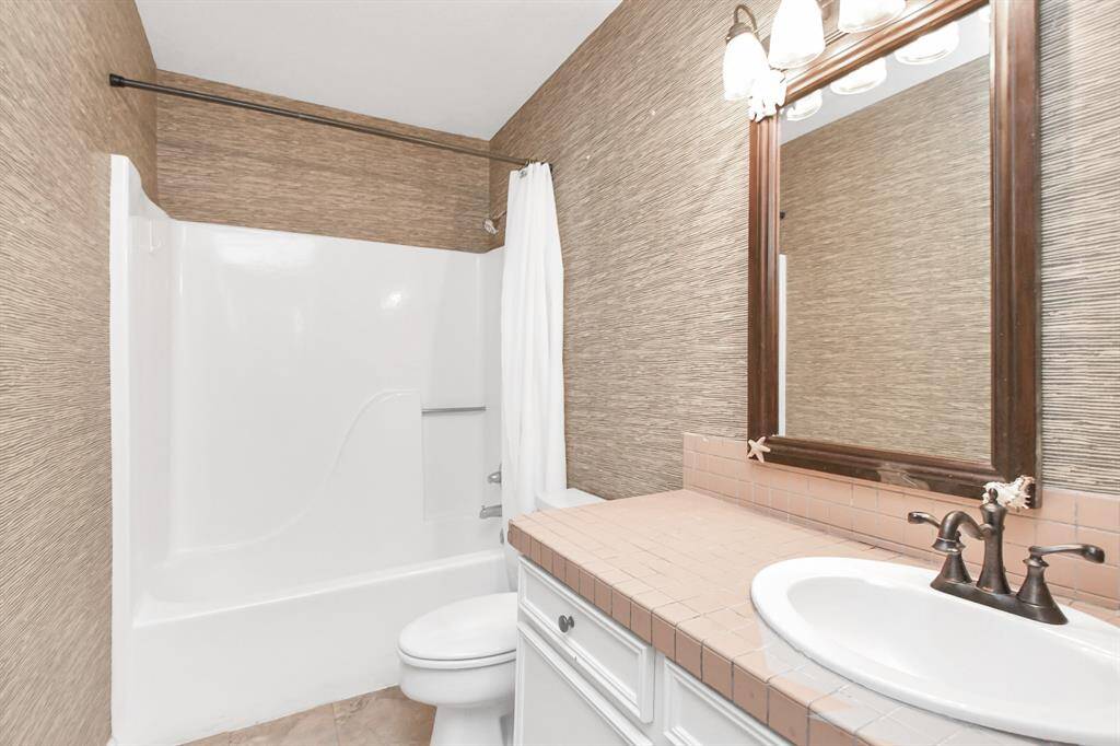 Bathroom featuring a convenient tub/shower combo.